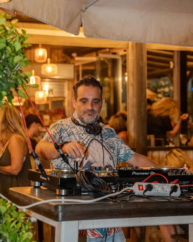 A DJ playing on the terrace in the evening